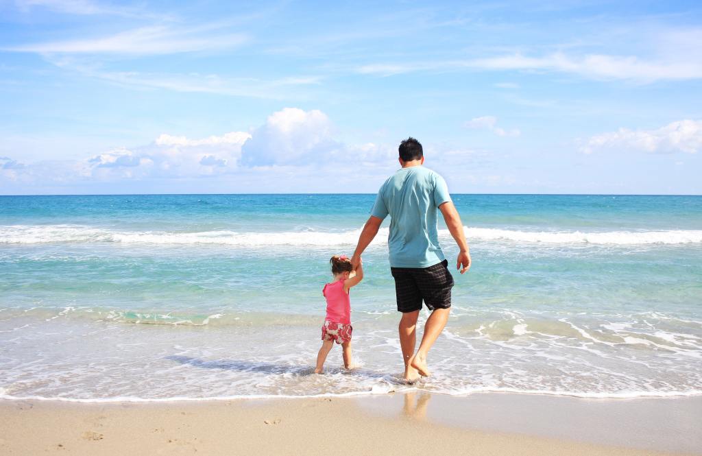 father and daughter in beach