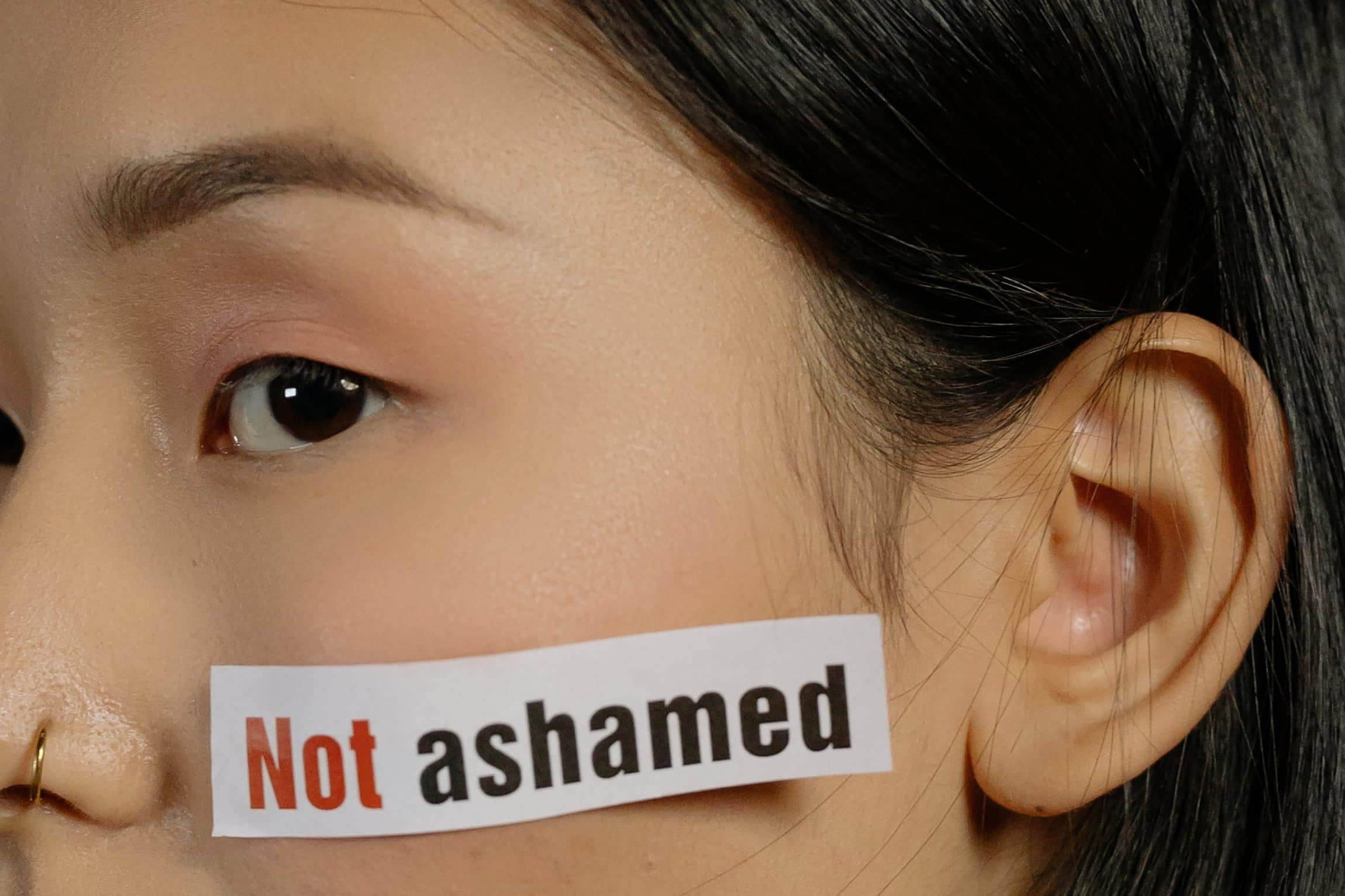 woman with not ashamed sticker