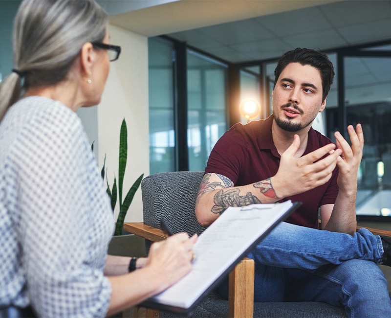Shot of a young man having a psychotherapy session with a psychologist